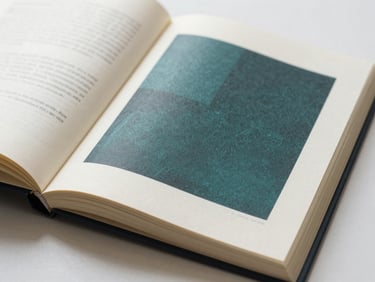 An open book showing elegant typography-driven interior layout, generous margins on premium cream paper, soft natural light.