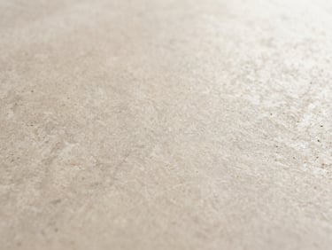 Macro shot of a natural stone texture, emphasizing organic patterns, soft morning light, warm minimalist tones.