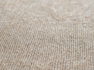 Tactile textile photography, extreme close-up of natural raw linen fabric weave, diffused daylight, neutral earth tones, high detail texture, 35mm