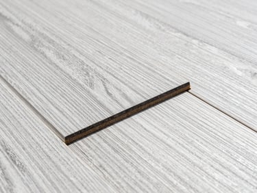 Extreme close-up of neatly laid engineered hardwood planks, showing flush joints and crisp wood grain, bright natural daylight, 35mm