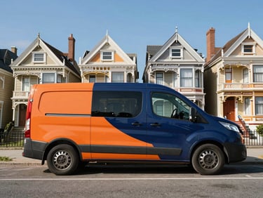 Wide environmental shot, bright clear daylight, branded van parked in a recognizable Victorian coastal suburb, rich navy and orange tones, 35mm lens