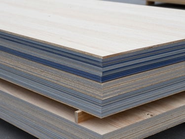 High-key technical studio shot of structural plywood sheets stacked in a clean warehouse, highlighting the precise thickness and uniform face veneer.