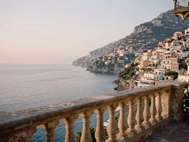 A secluded stone balcony overlooking the historic Amalfi coastline at golden hour, soft cinematic lighting, 35mm.