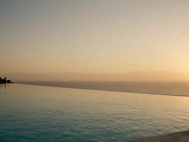 Architectural detail of a luxury villa with an infinity pool at golden hour, empty, serene, editorial luxury travel photography, warm golden-hour light, rich muted tones, elegant composition, 35mm film aesthetic