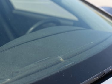 Macro close-up of the same windshield area after optical-grade resin injection, showing flawless restoration and near-invisible structural repair