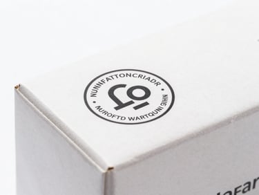 Close-up of a product box with an official manufacturer warranty seal, bright clean studio lighting, soft shadows, sharp focus, modern tech aesthetic