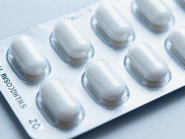 Macro photograph of sealed pharmaceutical packaging with secure verification codes, cool blue and sterile white tones, clinical daylight, sharp focus, 35mm.