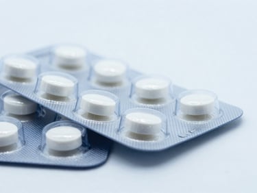 Macro close-up of sealed blister packs of cardiovascular medication, sterile white background, cool lighting, sharp focus.
