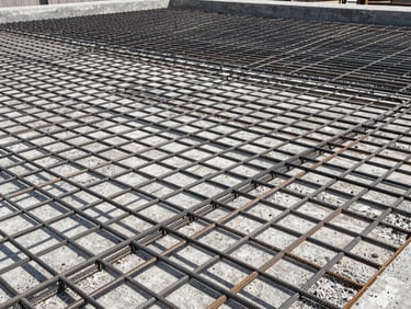 Interlocking structural steel rebar grid before concrete pouring, sharp geometric shadows, high-contrast daylight.