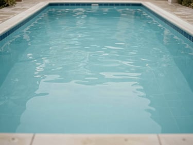 The same swimming pool interior after full renovation — smooth, uniform waterproof render surface with clean waterline tiles, no cracks or deposits visible, photographed in natural overcast daylight at eye level from the pool edge, no people, no lifestyle props