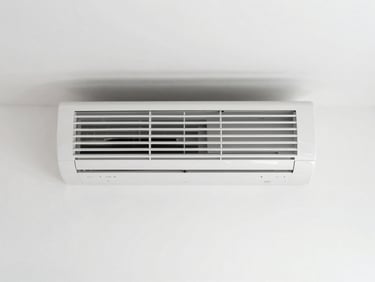 Symmetrical architectural shot of a clean, modern interior with an AC unit, Mediterranean daylight, high-contrast white walls
