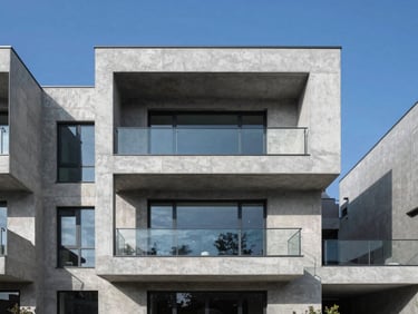 Modern high-end residential concrete villa facade with clean geometric lines, bright daylight, sharp high-contrast architectural shadows.