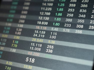 Macro close-up of a financial terminal showing real-time currency pricing, cool diffused studio lighting, desaturated slate tones.