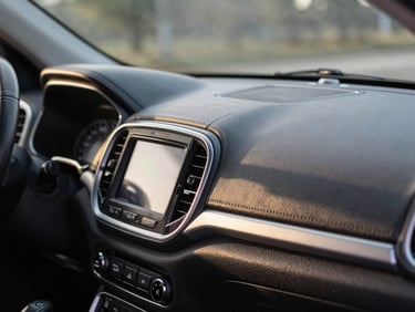 Polished detail of a clean Jeep Compass dashboard, sharp morning light reflecting on leather stitching, cinematic framing