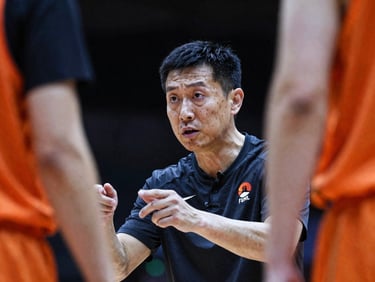 Tight telephoto crop of a coach with intense focus instructing a player, high-contrast indoor court lighting, gritty athletic photography.