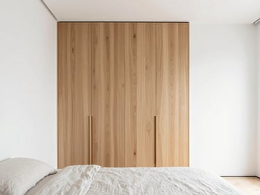 Sleek minimalist bedroom, integrated oak wood wardrobes, high-key natural daylight, neutral linen bedding, 35mm