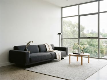Sleek minimalist living room with clean white walls, deep charcoal furniture, bright natural daylight from wide windows, architectural focus, 35mm