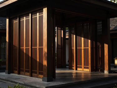 Dramatic architectural detail of a luxury resort pavilion in Southeast Asia, strong geometric shadows cast by floor-to-ceiling wooden screens, warm golden hour lighting.