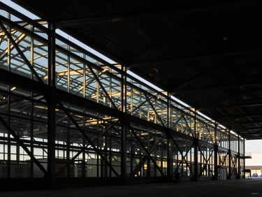 Abstract geometric structure of a modern steel and glass logistics terminal, high-contrast architectural lighting, dramatic shadows, sharp focus.