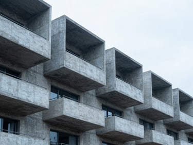 Architectural photograph of a collective housing building concrete shell, sharp focus on structural slabs, overcast cold light.