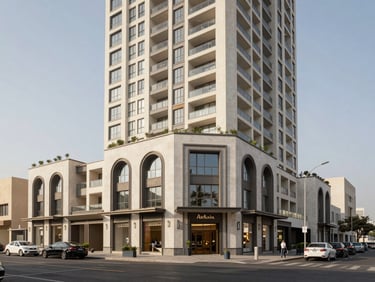 Exterior wide shot of a mixed-use development podium in Dubai, retail at grade with residential tower rising above, shot from across the street at midday, even daylight, no people, architectural clarity, neutral sky