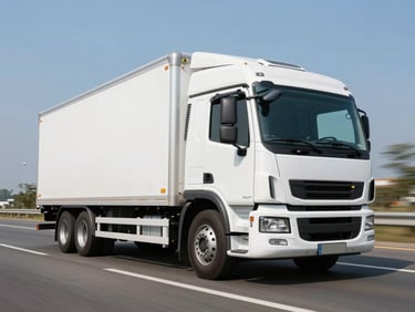 Low-angle dynamic tracking shot of a pristine white modern cargo truck on a clean highway under bright daylight, 35mm lens, high contrast.