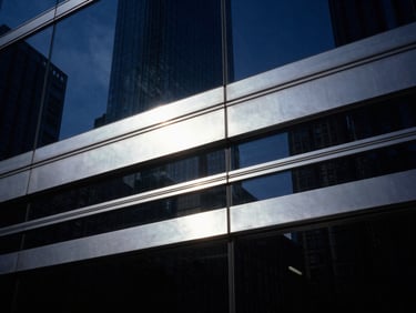 Abstract representation of clean data flow lines reflecting off a dark glass surface, cool silver highlights, deep shadows