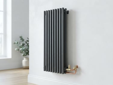 Modern slimline anthracite radiator mounted perfectly level on a white wall, neat copper pipe connections