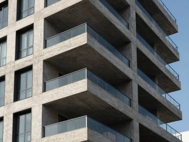Clean architectural lines of a premium modern residential building in Mexico, sharp concrete and glass under bright daylight, high contrast shadows.