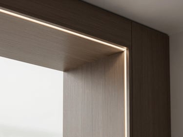 Close-up of seamless dark wood joinery with premium HPL finish, soft warm side lighting, architectural detail