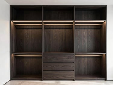 Minimalist walk-in closet with custom dark wood wardrobe, integrated warm LED lighting, clean lines, architectural photography