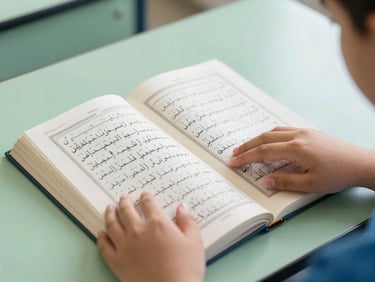 Close-up of a modern schoolbook open to a Quranic verse, with a young Arab student's hands gently touching the page, natural daylight, soft green and blue tones, shallow depth of field.