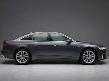Front three-quarter driver-side profile of a dark grey Audi A6 sedan, studio strobe lighting, full vehicle profile, squared frame, no artistic angle