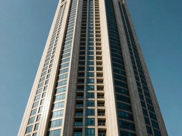 Exterior view of Nahar Tower in Deira, Dubai, bright daylight, showcasing the modern commercial building facade against a clear blue sky