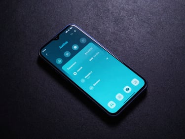 Top-down flat lay of a modern Android device on a dark textured surface, screen displaying a glowing cyan system diagnostics interface, low-key dramatic studio lighting with blue rim lights.