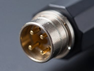 Close-up of a high-speed automotive data connector, gold-plated pins, precise metallic shielding, sharp macro photography