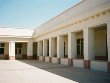 Clean, well-lit school corridor with architectural details of a classical building, bright Arizona daylight, 35mm, stately institutional photography