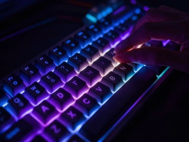 Close-up of hands on a mechanical keyboard with glowing RGB backlighting, shallow depth of field, cyber purple and electric blue ambient light reflections on keycaps.