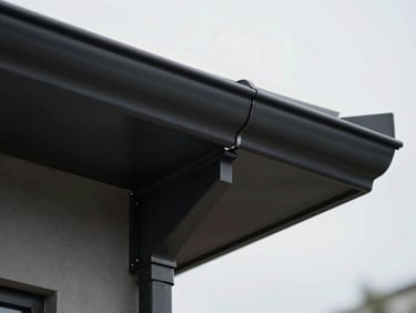 Extreme close-up architectural detail of a flush-mounted solar tile meeting a matte-black steel roof gutter, razor-sharp alignment, clean geometric lines, soft overcast daylight, sharp focus on the zero-tolerance seam.