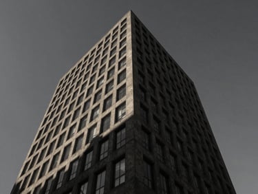 Wide-angle exterior shot of a tall, dark concrete office tower, harsh geometric shadows across its facade, against a moody sky, desaturated charcoal tones.