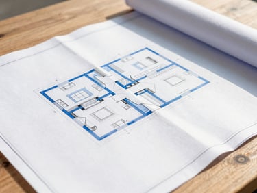 Close-up detail of architectural blueprints and site plans on a wooden table under natural morning daylight, sharp focus