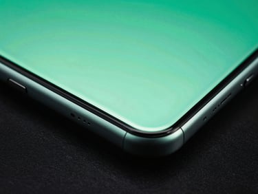 Dynamic angled close-up of a premium Android phone edge, mint green glow emanating from the screen, dark metallic textures, ultra-sharp detail