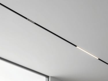 Looking up at a modern modular ceiling with clean lines and integrated linear lighting, minimalist design
