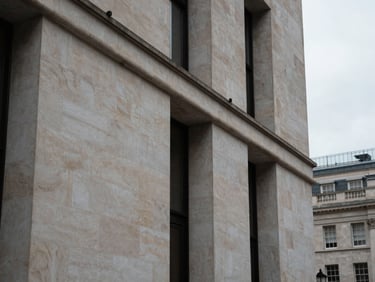 Abstract architectural detail of a modern Portland stone facade in Mayfair, soft overcast daylight, sharp focus, 35mm lens