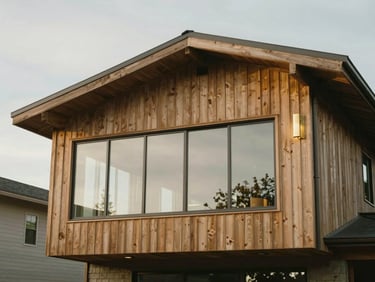 Exterior elevation of a modern West Coast home addition, cedar cladding, large glass windows, overcast soft daylight