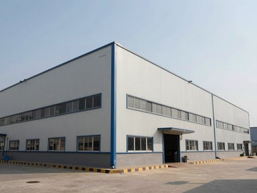 Wide shot of Sahibabad industrial area factory exterior under bright daylight, clean structural lines, functional design