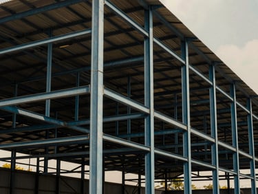Massive structural steel warehouse frame completed in Whitefield Bangalore, architectural photography, dramatic daylight, sharp details, 35mm