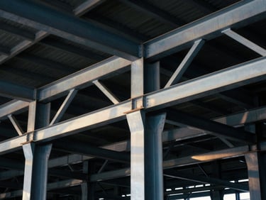 Close-up of industrial steel trusses and columns in a newly erected distribution center, high-contrast lighting, dramatic shadows, 35mm