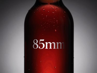 Low-key dramatic lighting on a 1.5L glass carafe bottle, elegant silhouette, minimal white typography on label.
