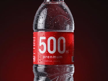 Studio product shot of a 500ml premium PET water bottle, crisp condensation droplets, custom crimson label.